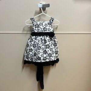 Black and white sleeveless baby dress with undershorts.